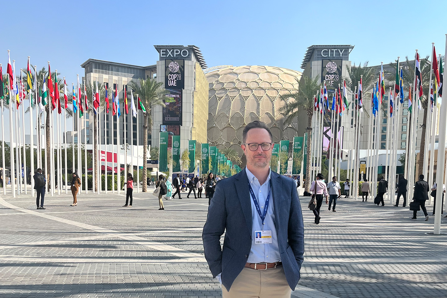 Damian Odgen posing at the entrance to COP28
