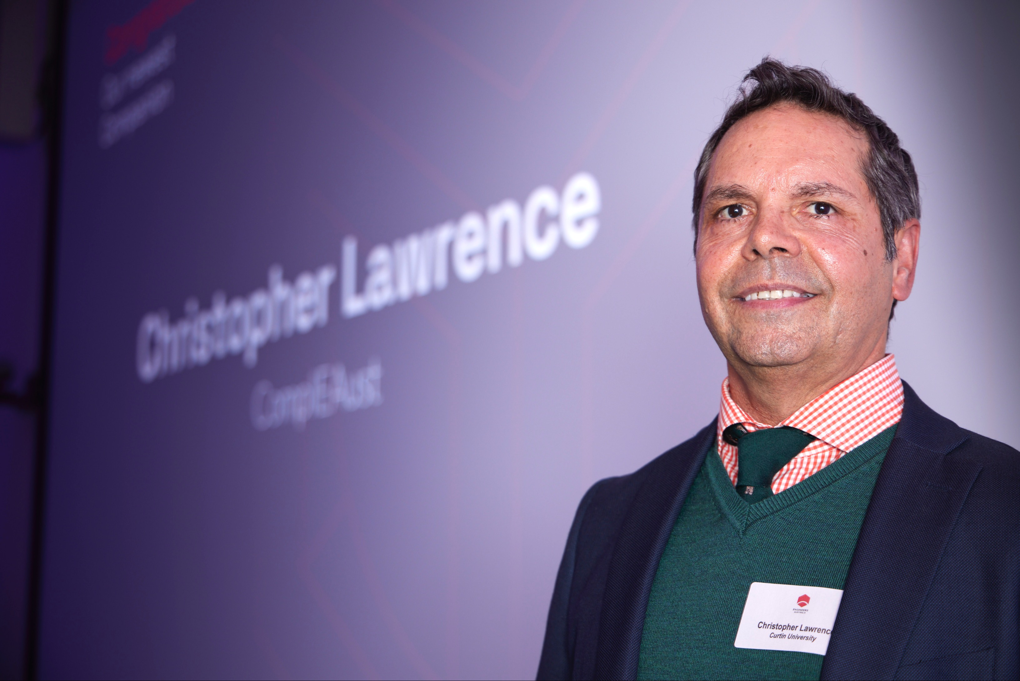 Christopher Lawrence in front of purple background